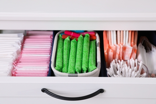 a open drawer showing neatly organized sanitary pads and tampons
